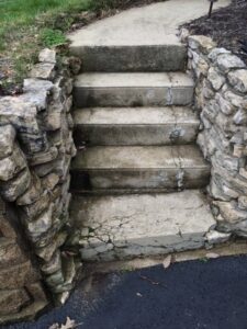 before hardscaping renovation, a stone staircase with cracks and damage