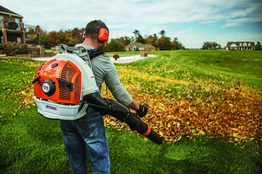 a man using a backpack style Stihl leaf blower